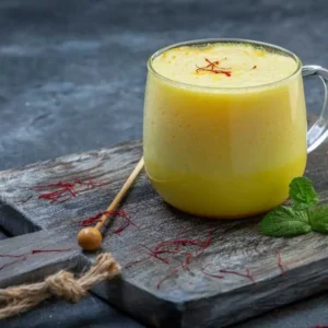 A glass of milk mixed with DNachiys Badam Drink Mix