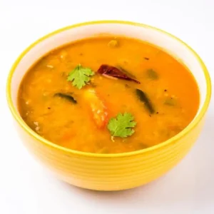 A bowl of sambar seasoned with DNachiys Drumstick Sambar Seasoning