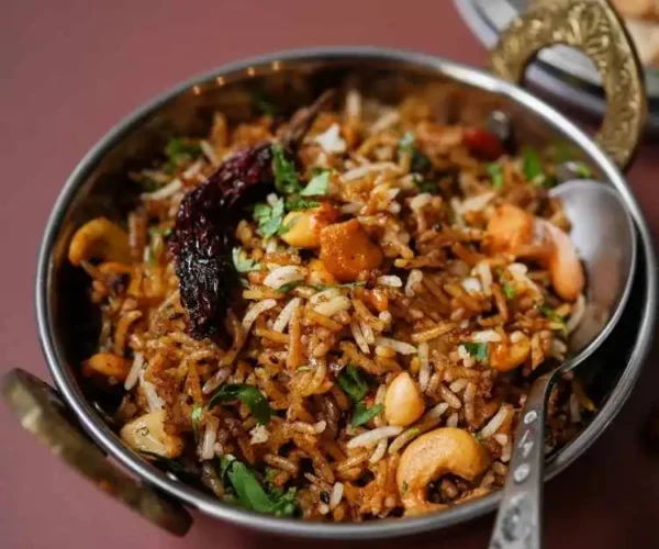 A bowl of rice mixed with DNachiys Puliyogare Mix A bowl of rice mixed with DNachiys Puliyogare Mix