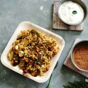 A plate of rice mixed with instant DNachiys Vangi Bath Masala served with curd