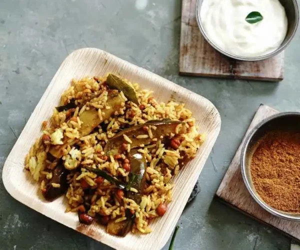 A plate of rice mixed with instant DNachiys Vangi Bath Masala served with curd A plate of rice mixed with instant DNachiys Vangi Bath Masala served with curd